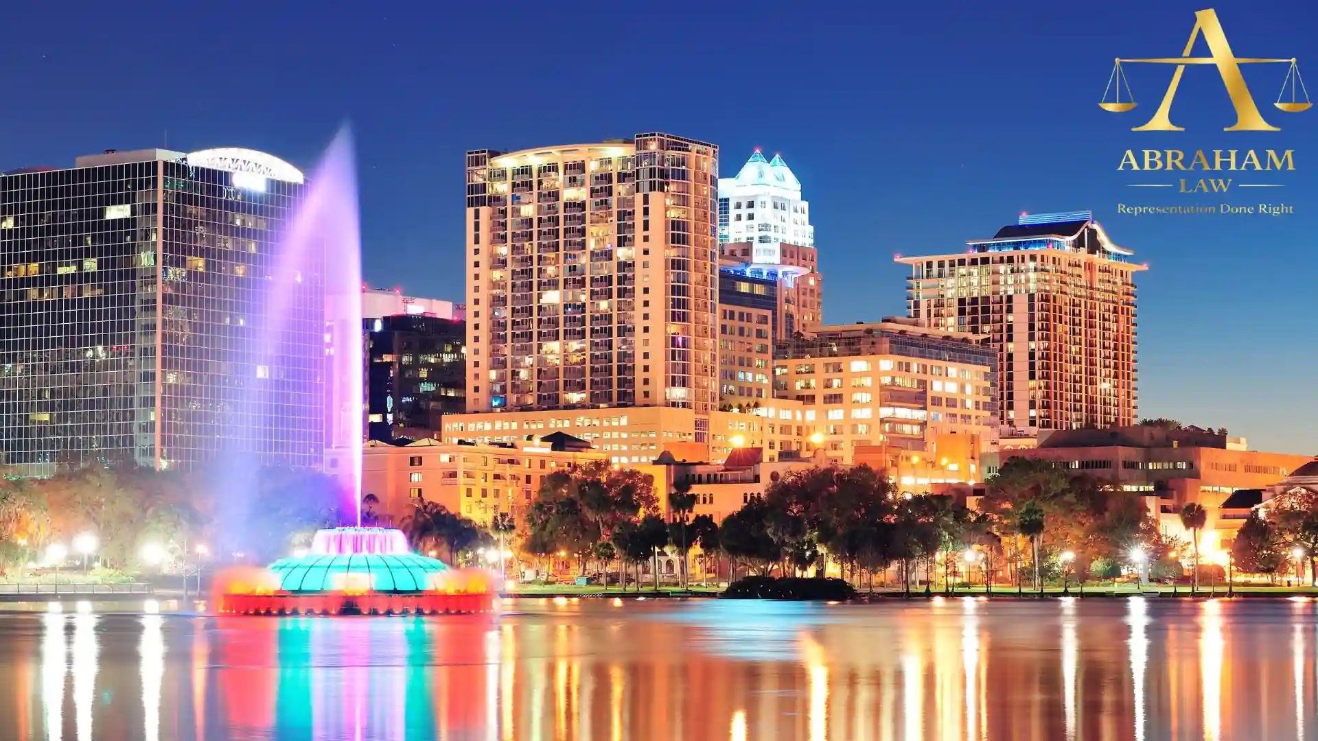 Orlando skyline at night with illuminated fountain.